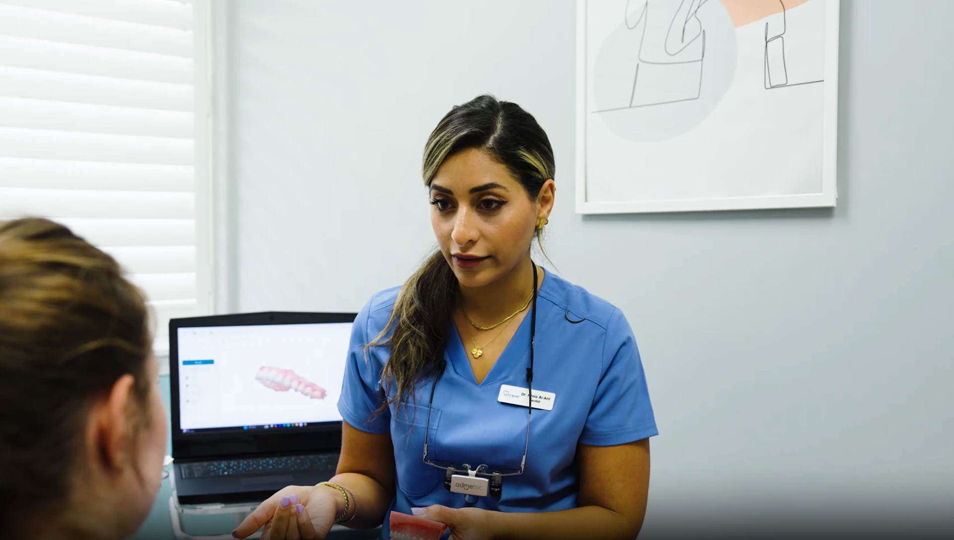 Dr. Israa Al-Ani consulting with a patient