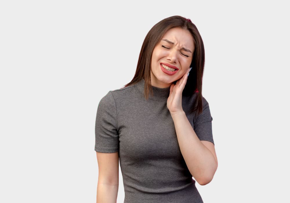 Woman holding her jaw due to severe tooth pain